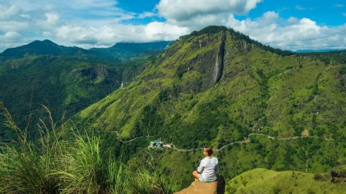 Tourists hiking to the summit of Little Adam's Peak with mountain views in Ella